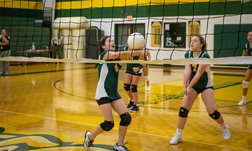 A volleyball player bumps the ball